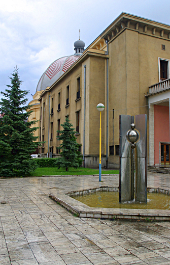 Slovakia Weather - The Status Quo (foreground) and - the These building have been taken over - as the home of the Slovak philharmonic. - There is no sign of their previous 